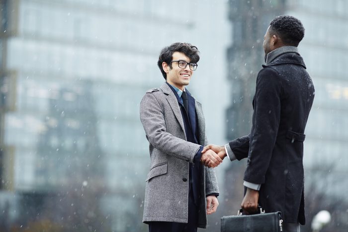 Business partners shaking hands in trust